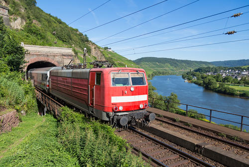 Train leaving a tunnel near the river Moselle in Germany